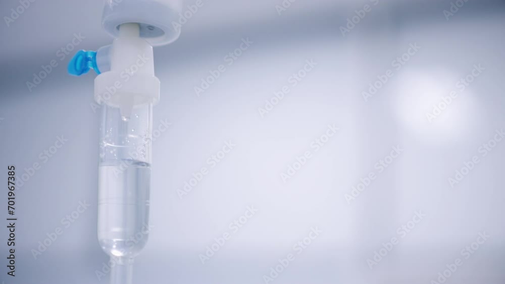 Close up of drops falling from saline liquid bag at the hospital Close up of drops falling from saline liquid bag at the hospital