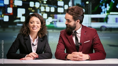 Принти на полотні Media team hosting night talk show, discussing about international daily events in news studio
