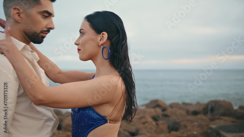 Hot passionate latino performers dancing together on cloudy ocean coast close up © stockbusters