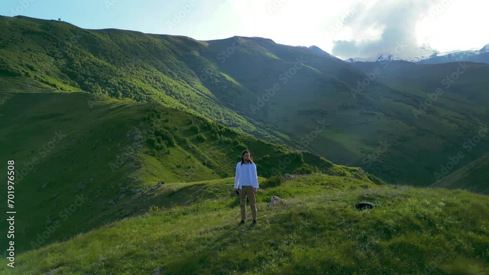 aerial video - a man against a background of a green mountain landscape aerial video - a man against a background of a green mountain landscape