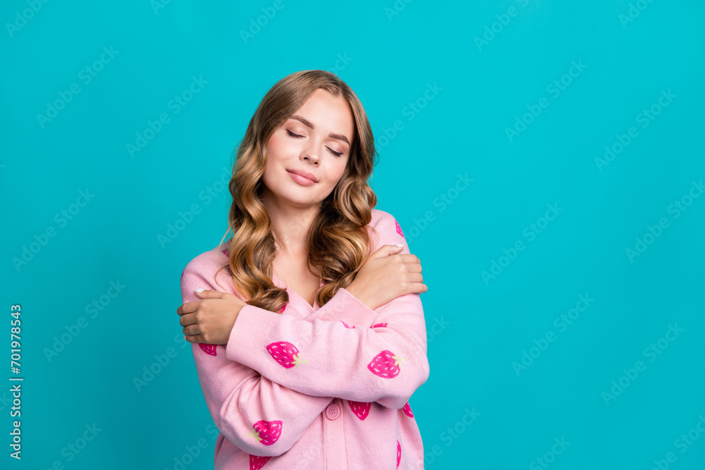 Photo of young brown curly hair lady wear pink pullover closed eyes comfy clothes cuddle shoulders isolated on blue color background Photo of young brown curly hair lady wear pink pullover closed eyes comfy clothes cuddle shoulders isolated on blue color background