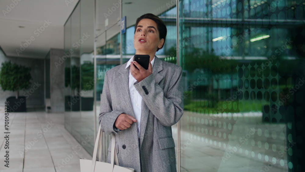 Executive dictate voice message at office. Confident woman use virtual assistant Executive dictate voice message at office. Confident woman use virtual assistant