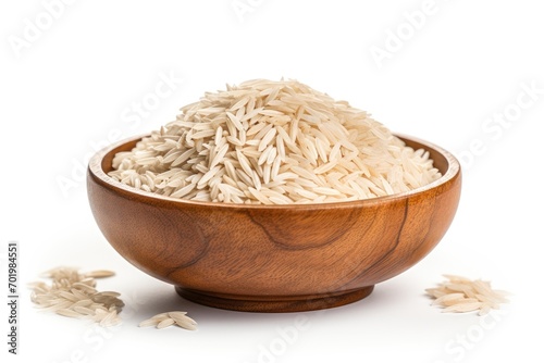 Isolated basmati rice in wooden bowl on white background photo