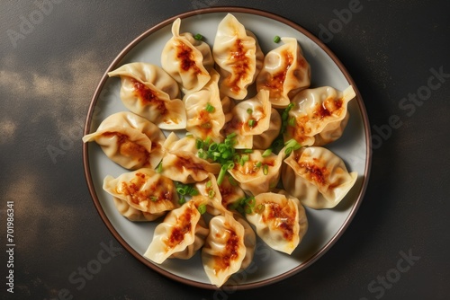 Top view of gyoza dumplings on a plate against a gray concrete background