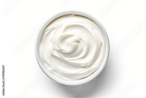 Top view of isolated bowl of sour cream or Greek yogurt on white background photo