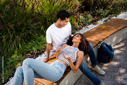 Photo of positive pretty couple spending free time enjoy weekend trip journey vacation walk in park sunshine outside