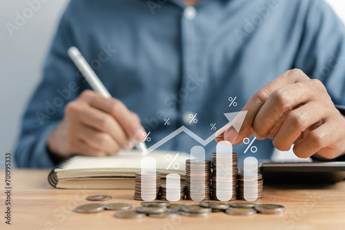 Businessman stacking money coins accounting for increase financial interest rate and business investment growth from dividend, Business Finance and Money, Save money for prepare in the future.