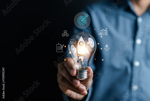 Rocket launch idea inside lightbulb with arrows up. strategically planning and initiating a corporate startup. aim to achieve objectives through value development, fostering leadership.