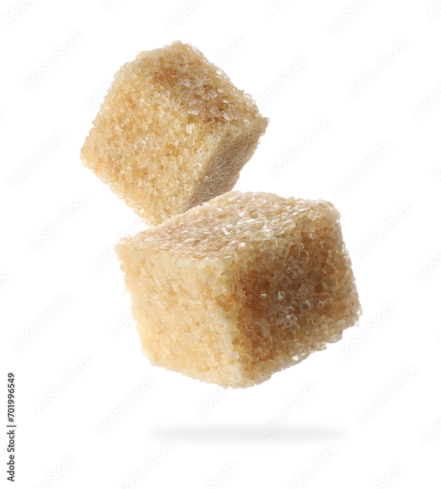 Cubes of brown sugar falling on white background Cubes of brown sugar falling on white background