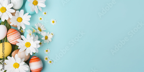 Lots of flowers and colorful Easter eggs on a light blue background with copy space