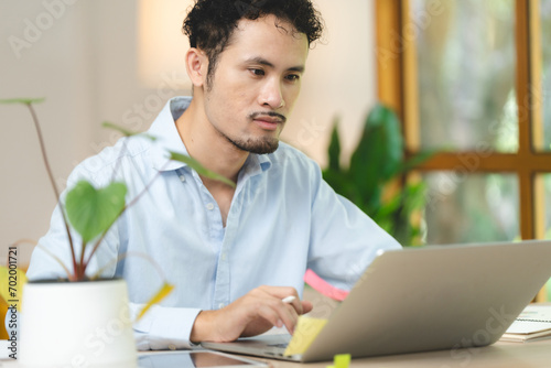 Young smiling asian man rel...