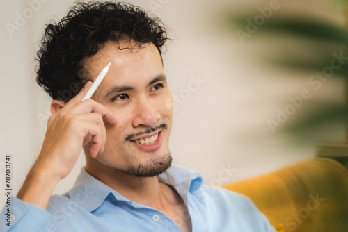 Young smiling asian man rel...
