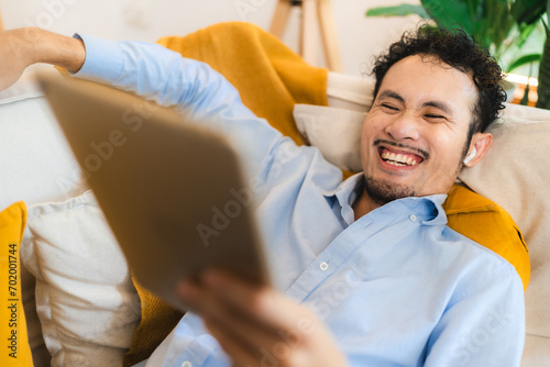 Young smiling asian man rel...