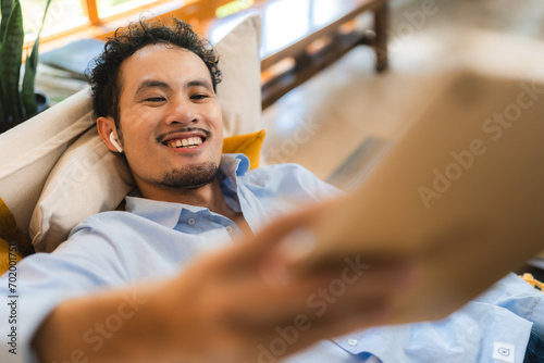 Young smiling asian man rel...