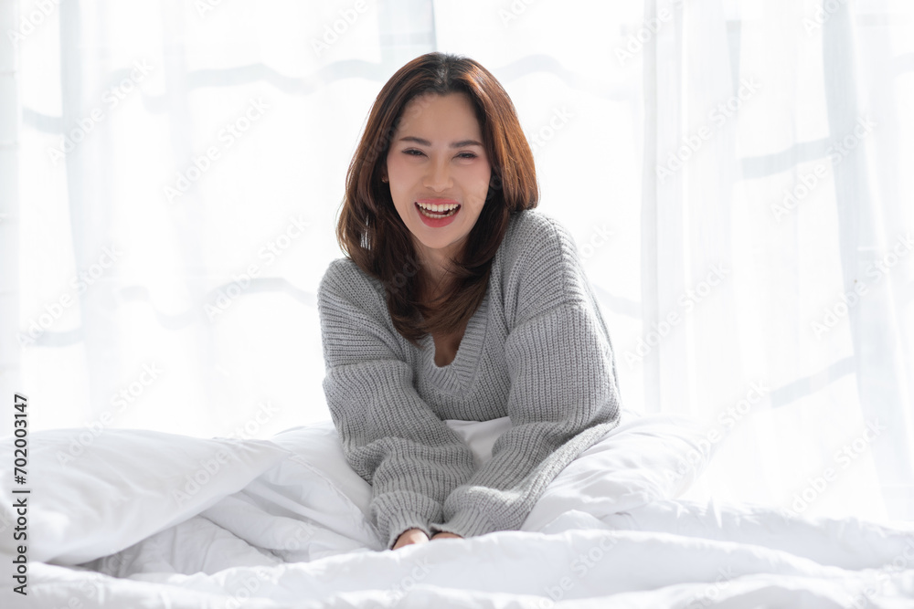 Stunning Beautiful Attractive Asian young woman sit on bed looking at camera and smile happiness and comfortable at home.Cute girl smile cross arm confident and relax in bed room Stunning Beautiful Attractive Asian young woman sit on bed looking at camera and smile happiness and comfortable at home.Cute girl smile cross arm confident and relax in bed room
