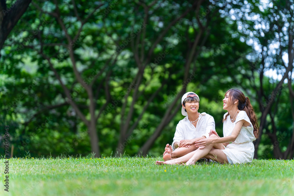 Happy young Asian woman enjoy and fun outdoor lifestyle travel nature on summer holiday vacation. Generation z girl friends relaxing and using mobile taking selfie together at park. Happy young Asian woman enjoy and fun outdoor lifestyle travel nature on summer holiday vacation. Generation z girl friends relaxing and using mobile taking selfie together at park.