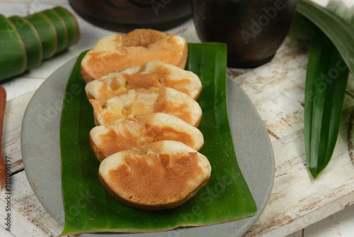 Kue Pukis or pukis cake , Traditional Javanese half-moon shaped pancakes. made from flour eggs yeast and coconut milk.on white background photo