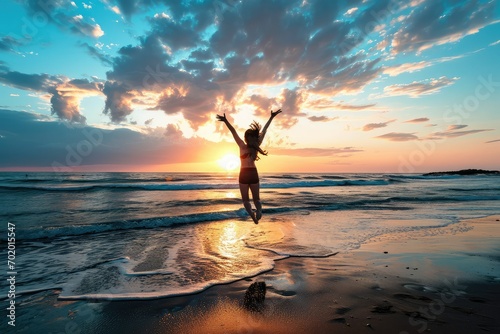 A determined woman on the beach at dawn, her joyful jump symbolizing the overcoming of obstacles and the welcoming of a sunrise filled with new possibilities.