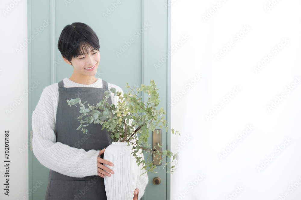 Image of a florist store salesman, customer service worker, or housewife holding a vase of flowers. Image of a florist store salesman, customer service worker, or housewife holding a vase of flowers.