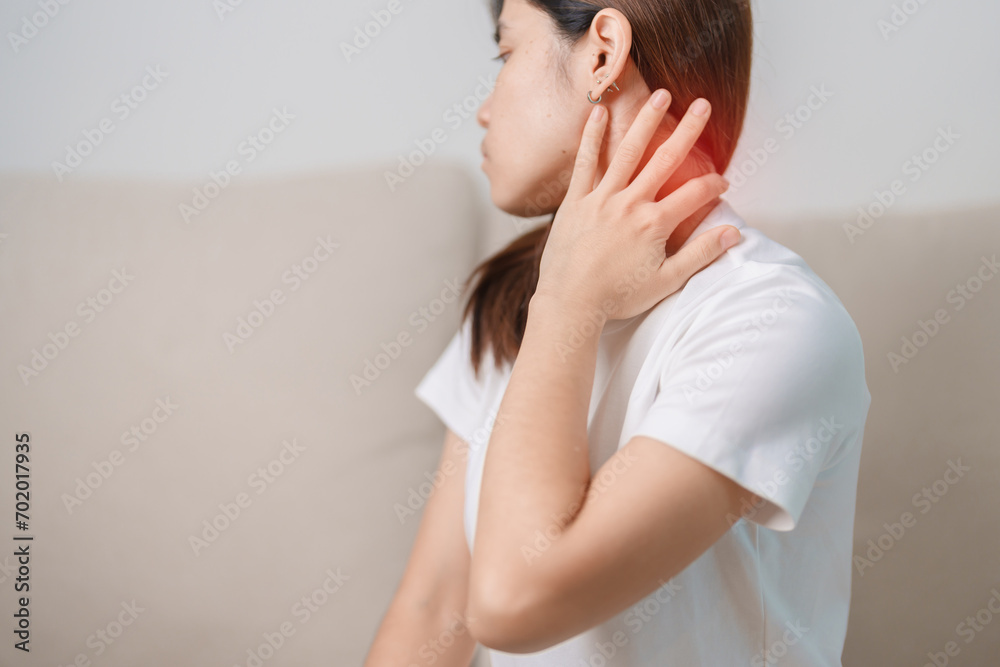 Woman having Neck and Shoulder pain during sitting on couch at home