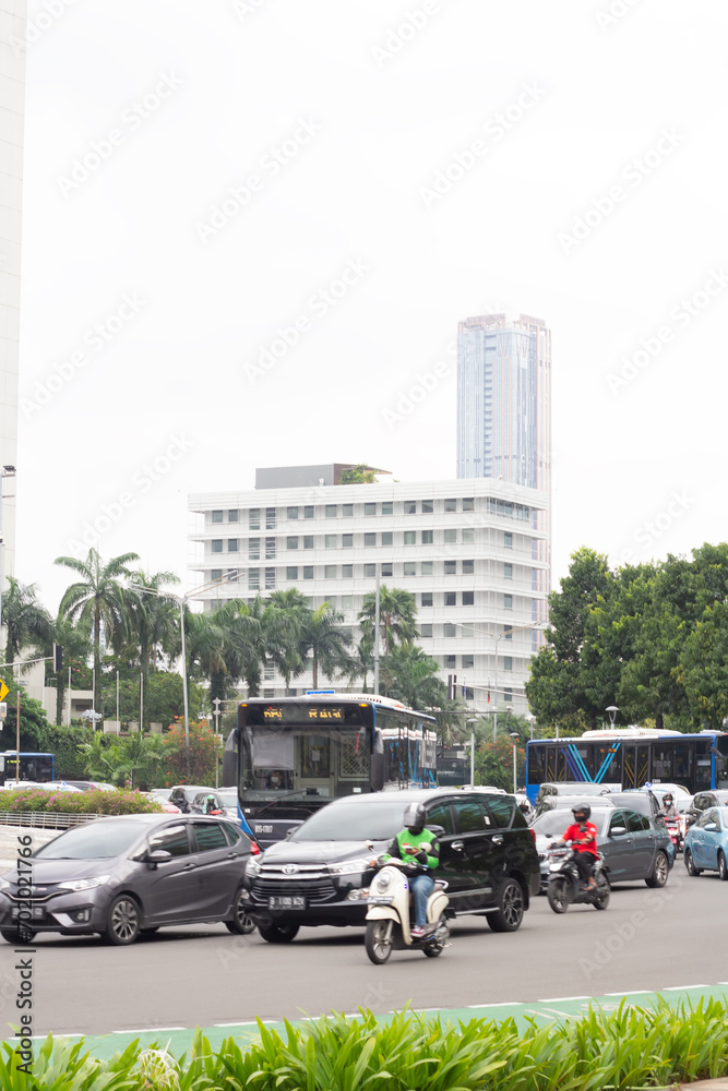 The area around Bundaran HI in Jakarta experiences high density, with public transportation, street vendors, and workers passing through, Jakarta, Indonesia, January 12nd 2022