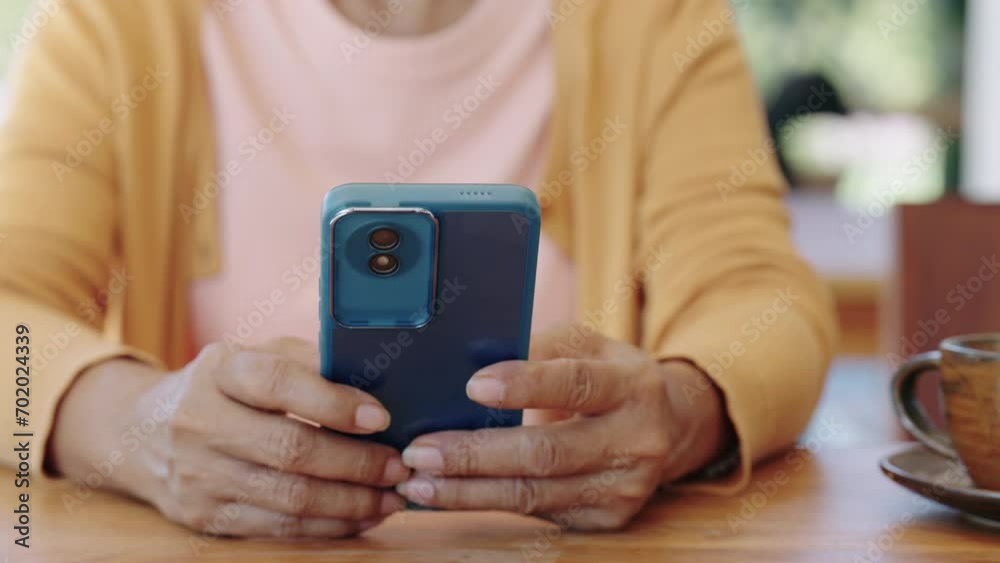 closeup Finger of woman touching scroll page app on mobile phone at room.Manager typing telephone alone watch film online. closeup Finger of woman touching scroll page app on mobile phone at room.Manager typing telephone alone watch film online.