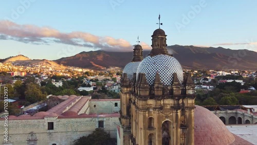 backwards drone shot of Santo Domingo temple in downtown Oaxaca city in Mexico photo