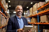 Portrait of smiling mature businessman using digital tablet in warehouse at warehouse, Cheerful warehouse manager doing inventory control with a digital tablet, AI Generated