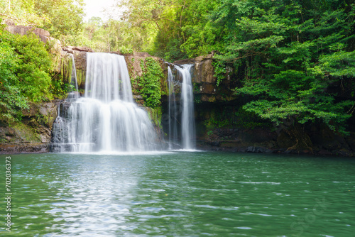 Klong Chao waterfall serenely cascades and green water below in Koh Kood island, Thailand.