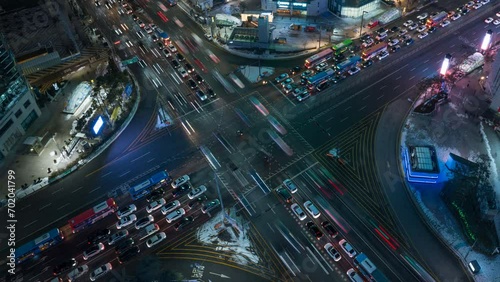 Seoul Gangnam District at Night. Cars, Buses, Vehicles Turning at the Busy Road Intersection Surrounded by Modern Skyscrapers - Aerial Top View photo