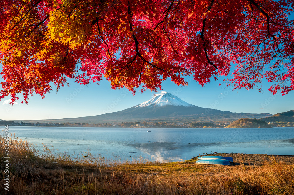 Landscape of lake kawaguchiko during autumn season with maple red leaves and mountain fuji background