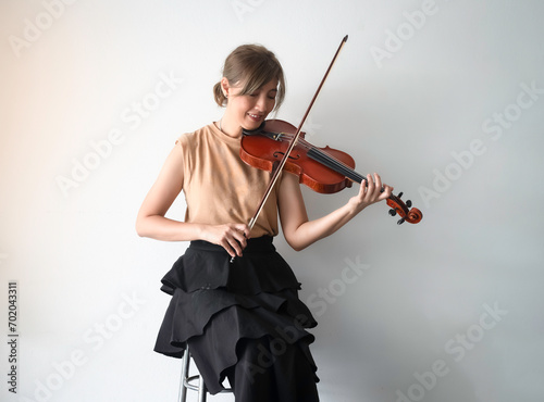 Woman playing violin with happy feeling,practice acoustic instrumen