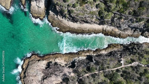 Top down Static Drone shot of Stradbroke Islands Point Lookout North Gorge. Waves hitting rock walls, sting ray swimming in the water below. 4K QLD Australia Tourism photo