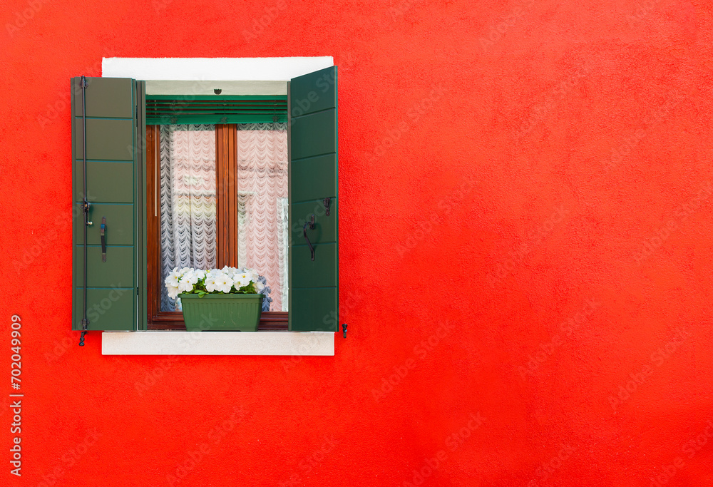 Colorful wall and window of residential house in Burano island, Venice, Italy