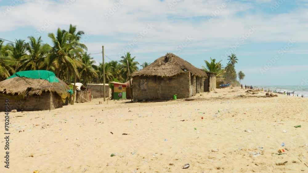 Wide view of primitive buildings on sand beach in Moree village, Ghana Wide view of primitive buildings on sand beach in Moree village, Ghana