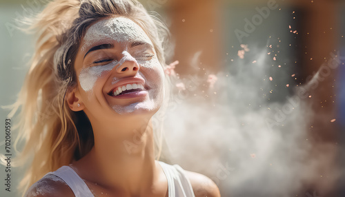 Happy woman with holi colors on her face and in her hair festival of colors ,spring concept