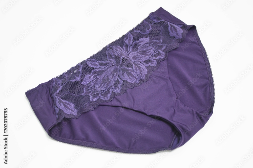 Lingerie. Purple panties with lace trim on the front on a white background. Beautiful colored fashionable lingerie
