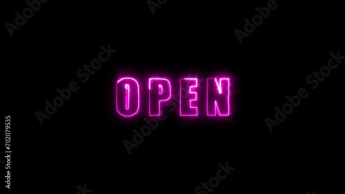 Neon sign with the word open in bright pink on a dark background.