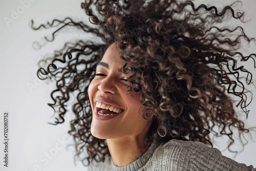 a woman with curly hair laughing