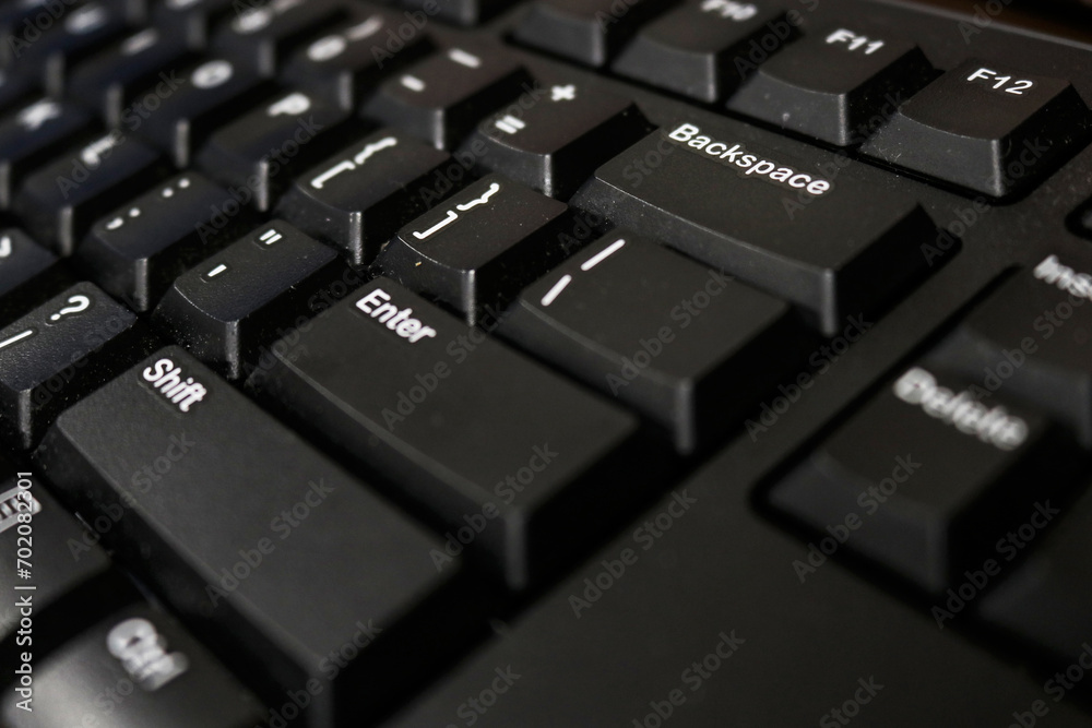 Photo of the black keyboard of a personal computer in an office Photo of the black keyboard of a personal computer in an office