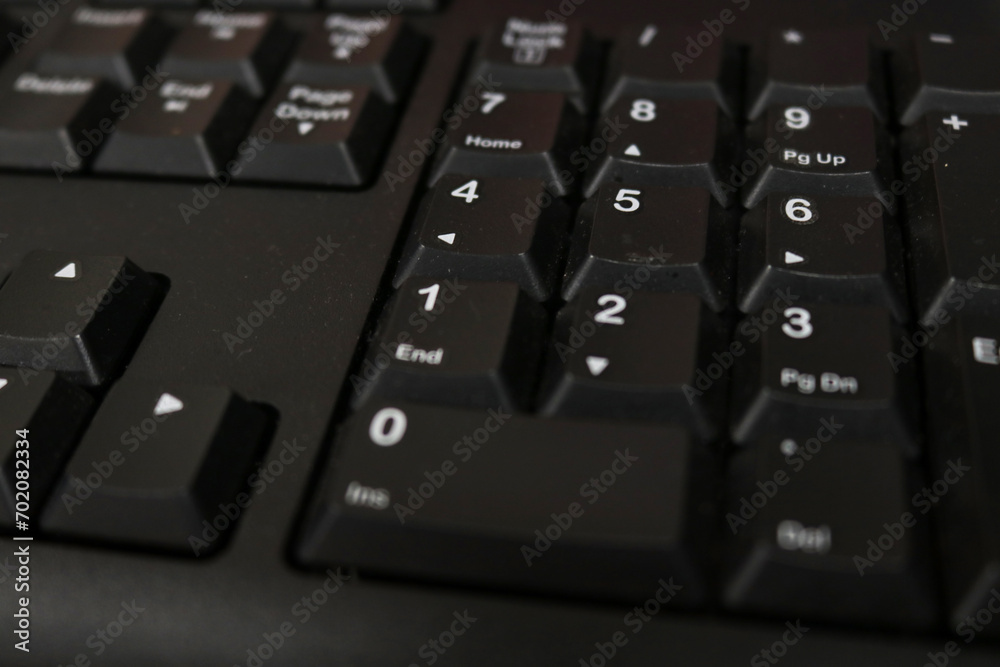 Photo of the black keyboard of a personal computer in an office Photo of the black keyboard of a personal computer in an office