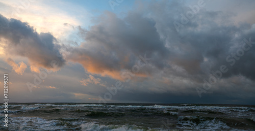 Panorama of storm clouds over the sea during sunset