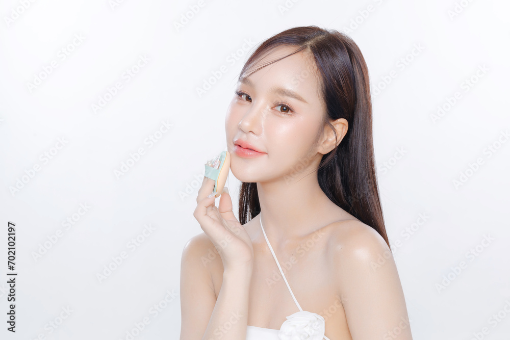 Young Asian woman long hair with clean fresh skin Korean makeup using puff on white background, Female model Face care, Facial treatment, Cosmetology, beauty and spa, Asian women portrait.