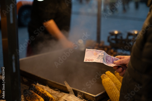Istanbul, Turkey - December 31 2023:  a traditional Turkish street vendor outside the spice bazaar sells corn