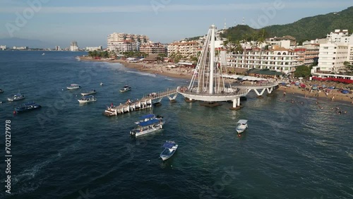 Aerial Drone Zoom Out Pier Boats, Puerto Vallarta Mexican Beach Town, Blue Ocean in Pacific Coastline photo