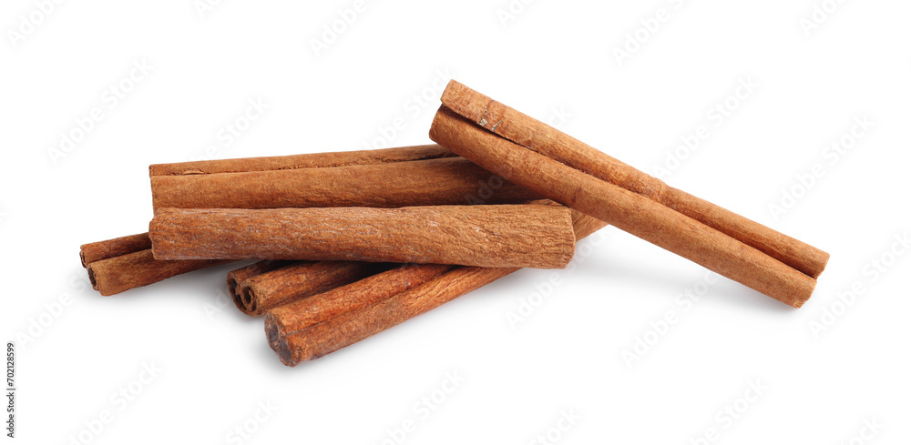 Pile of aromatic cinnamon sticks isolated on white Pile of aromatic cinnamon sticks isolated on white