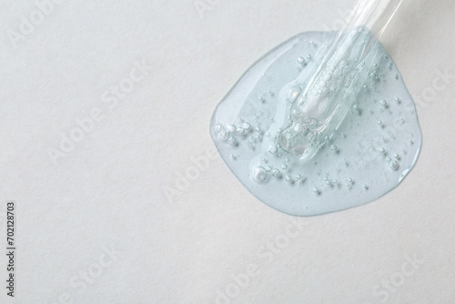 Pipette with cosmetic serum on white background, top view. Space for text © New Africa
