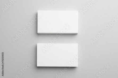 Blank business cards on light gray background, top view. Mockup for design © New Africa