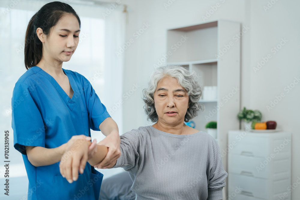 senior woman doing exercise at clinic with physiotherapist. help of a personal trainer during a rehabilitation session. senior woman doing exercise at clinic with physiotherapist. help of a personal trainer during a rehabilitation session.