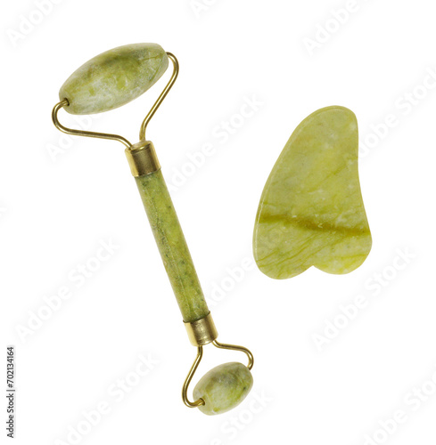 Green jade roller and gua sha stone for facial massage and isolated on transparent background. Facial massage tool. Green quartz jade roller  photo